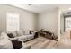 Cozy living room featuring neutral walls, wood-look floors, and a comfortable sectional sofa at 10086 Mountain Foothills Ave, Las Vegas, NV 89149
