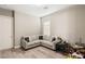 Cozy living room featuring neutral walls, wood-look floors, and a comfortable sectional sofa at 10086 Mountain Foothills Ave, Las Vegas, NV 89149