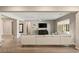 Open-concept living space with a comfortable sofa, wood-look floors, neutral colors, and a media center at 10086 Mountain Foothills Ave, Las Vegas, NV 89149
