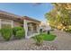 A backyard showcasing a covered patio, barbecue area, and well-maintained desert landscaping at 10309 Broom Hill Dr, Las Vegas, NV 89134