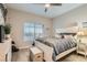 Comfortable bedroom with white furniture, wood-look flooring, and a ceiling fan at 10309 Broom Hill Dr, Las Vegas, NV 89134
