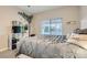 Bedroom featuring neutral decor, a large window with blinds, and a cozy bed with decorative pillows at 10309 Broom Hill Dr, Las Vegas, NV 89134