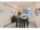 Formal dining room with modern table and chairs, decorative accents, and light-filled windows at 10309 Broom Hill Dr, Las Vegas, NV 89134