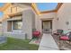 Inviting front entrance with seating, a decorative wreath, and well-maintained landscaping at 10309 Broom Hill Dr, Las Vegas, NV 89134