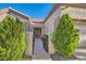 Charming entrance featuring well-maintained landscaping, walkway and beautiful front door at 10309 Broom Hill Dr, Las Vegas, NV 89134