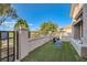 Attractive front yard with artificial grass and wrought iron gate to the walkway at 10309 Broom Hill Dr, Las Vegas, NV 89134