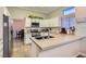 Stylish kitchen boasting white cabinets, subway tile backsplash, stainless steel appliances, and a center island at 10309 Broom Hill Dr, Las Vegas, NV 89134