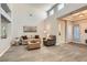 Spacious living room boasting high ceilings, wood-look tile flooring, and ample natural light at 10309 Broom Hill Dr, Las Vegas, NV 89134