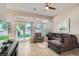 Bright living room featuring a comfortable sectional, stylish decor, and sliding doors to the backyard at 10309 Broom Hill Dr, Las Vegas, NV 89134