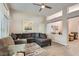 Cozy living room with a ceiling fan, comfortable seating, and wood-look tile flooring at 10309 Broom Hill Dr, Las Vegas, NV 89134
