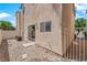 This is a cozy backyard featuring a rock landscape and a stucco wall with a sliding glass door at 11164 African Sunset St, Henderson, NV 89052