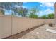 Cozy backyard area with a gravel ground cover and a white fence surrounding the space at 11164 African Sunset St, Henderson, NV 89052