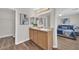 Bathroom showcasing double sinks, granite countertops, and an open doorway to the main bedroom at 11164 African Sunset St, Henderson, NV 89052
