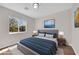 Comfortable bedroom featuring a queen bed, bedside tables, and large picture window at 11164 African Sunset St, Henderson, NV 89052