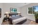 Well-lit bedroom featuring neutral decor, a large window, and a soothing color palette at 11164 African Sunset St, Henderson, NV 89052