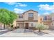 Charming two-story home with a neutral color palette, a two-car garage, and manicured landscaping at 11164 African Sunset St, Henderson, NV 89052