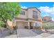Two-story home with a well-manicured front yard, a two-car garage, and a welcoming entrance at 11164 African Sunset St, Henderson, NV 89052