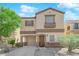 Inviting two-story home features a charming facade and attached garage with a well-manicured front yard at 11164 African Sunset St, Henderson, NV 89052