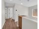Upstairs hallway with wood floors, security system and bedroom doors at 11164 African Sunset St, Henderson, NV 89052