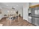 Open floor plan with eat-in dining area, stainless steel refrigerator, and living room at 11164 African Sunset St, Henderson, NV 89052