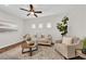 Bright living room with a comfortable sofa, chair, coffee table, and natural light from the windows at 11164 African Sunset St, Henderson, NV 89052