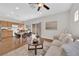 Open-concept living space with a modern kitchen, dining area, and comfortable seating, bathed in natural light at 11164 African Sunset St, Henderson, NV 89052