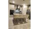 Bright kitchen featuring stainless steel appliances, granite countertops, pendant lighting, and a center island at 11815 Corenzio Ave, Las Vegas, NV 89138