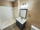 Bathroom featuring a tub and shower combination with a blue vanity and white countertop at 1300 S Arlington St # 202, Las Vegas, NV 89104