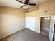 Bedroom with neutral walls, carpet, a ceiling fan, a closet and a view into a tiled bathroom at 1300 S Arlington St # 202, Las Vegas, NV 89104