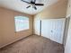 Bedroom featuring carpet flooring, a ceiling fan, a window, and a sliding door closet at 1300 S Arlington St # 202, Las Vegas, NV 89104
