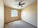 Neutral bedroom with a ceiling fan, a window and carpet flooring at 1300 S Arlington St # 202, Las Vegas, NV 89104