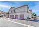 Condos with garages feature cream stucco, red roof tiles, and individual garages at 1300 S Arlington St # 202, Las Vegas, NV 89104