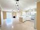 Open concept showcasing a kitchen with white cabinets, a breakfast bar, and stainless appliances at 1300 S Arlington St # 202, Las Vegas, NV 89104
