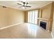 A spacious living room boasts wood floors, a ceiling fan, and a cozy fireplace at 1300 S Arlington St # 202, Las Vegas, NV 89104