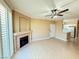 A bright living room includes a fireplace, ceiling fan, wood floors, and a view of the kitchen at 1300 S Arlington St # 202, Las Vegas, NV 89104