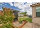 Landscaped backyard featuring a covered patio area with artificial grass and desert landscaping at 1401 Cattail Falls St, Boulder City, NV 89005