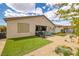 Backyard with artificial grass, a barbecue area, and relaxing patio overlooking desert landscaping at 1401 Cattail Falls St, Boulder City, NV 89005