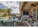 Relaxing covered patio with an outdoor dining area and barbecue overlooking the well-maintained backyard at 1401 Cattail Falls St, Boulder City, NV 89005