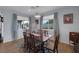 Bright dining room featuring hardwood floors, large windows, and modern chandelier at 1401 Cattail Falls St, Boulder City, NV 89005