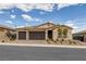 Inviting single-story home with a manicured front yard, desert landscaping, and a three-car garage at 1401 Cattail Falls St, Boulder City, NV 89005