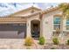 Inviting front exterior showcasing the home's facade, landscaping, and three-car garage at 1401 Cattail Falls St, Boulder City, NV 89005