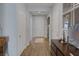 Bright hallway featuring neutral walls, wood-look tile flooring, and white trim at 1401 Cattail Falls St, Boulder City, NV 89005