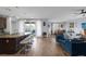 Open-concept kitchen featuring granite countertops, seating, stainless steel appliances, and an adjacent living area at 1401 Cattail Falls St, Boulder City, NV 89005
