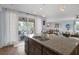 A kitchen island featuring a double sink with stainless steel appliances and sliding glass doors to the patio at 1401 Cattail Falls St, Boulder City, NV 89005