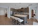 Spacious kitchen with dark cabinetry, stainless steel appliances, granite countertops, and an eat-in island at 1401 Cattail Falls St, Boulder City, NV 89005