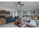 A modern open-concept living area with a kitchen, dining area and comfortable seating at 1401 Cattail Falls St, Boulder City, NV 89005