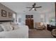 Spacious main bedroom featuring a ceiling fan, carpeted floors, and armchair at 1401 Cattail Falls St, Boulder City, NV 89005