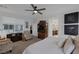 Bright main bedroom featuring a ceiling fan, carpeted floors, and a TV cabinet at 1401 Cattail Falls St, Boulder City, NV 89005