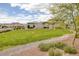 Lush community park featuring open green space, walking paths, and seating areas at 1401 Cattail Falls St, Boulder City, NV 89005