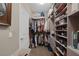 Walk-in closet with custom shelving and ample storage space for clothes and shoes at 1401 Cattail Falls St, Boulder City, NV 89005